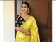 Kajol looks elegant in this yellow silk sari