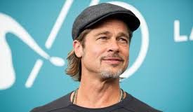 Brad Pitt obliges for a selfie with a fan after his attempt to go unnoticed fails
