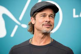 Brad Pitt obliges for a selfie with a fan after his attempt to go unnoticed fails